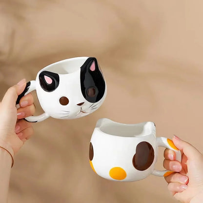 Person Holding Two Cat Coffee Mugs