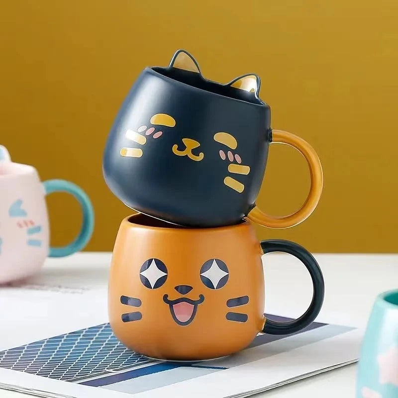 Two Cute Cat Mugs in Navy Blue and Orange stacked on top of one another 