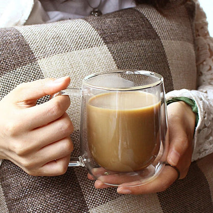 Person Holding Double Walled Glass Mug With Coffee Inside