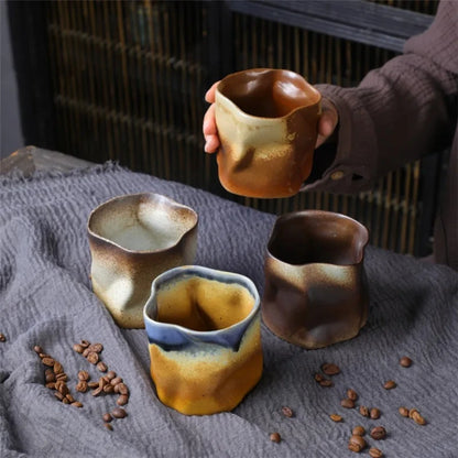 Person holding a Mexican Ceramic Cup in caramel with three Mexican Ceramic Cups next to 