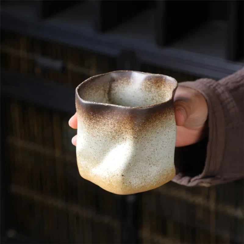 Person holding a Mexican Ceramic Cup in milky brown