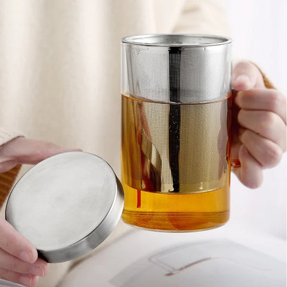 Person Holding Tea Mug With Infuser