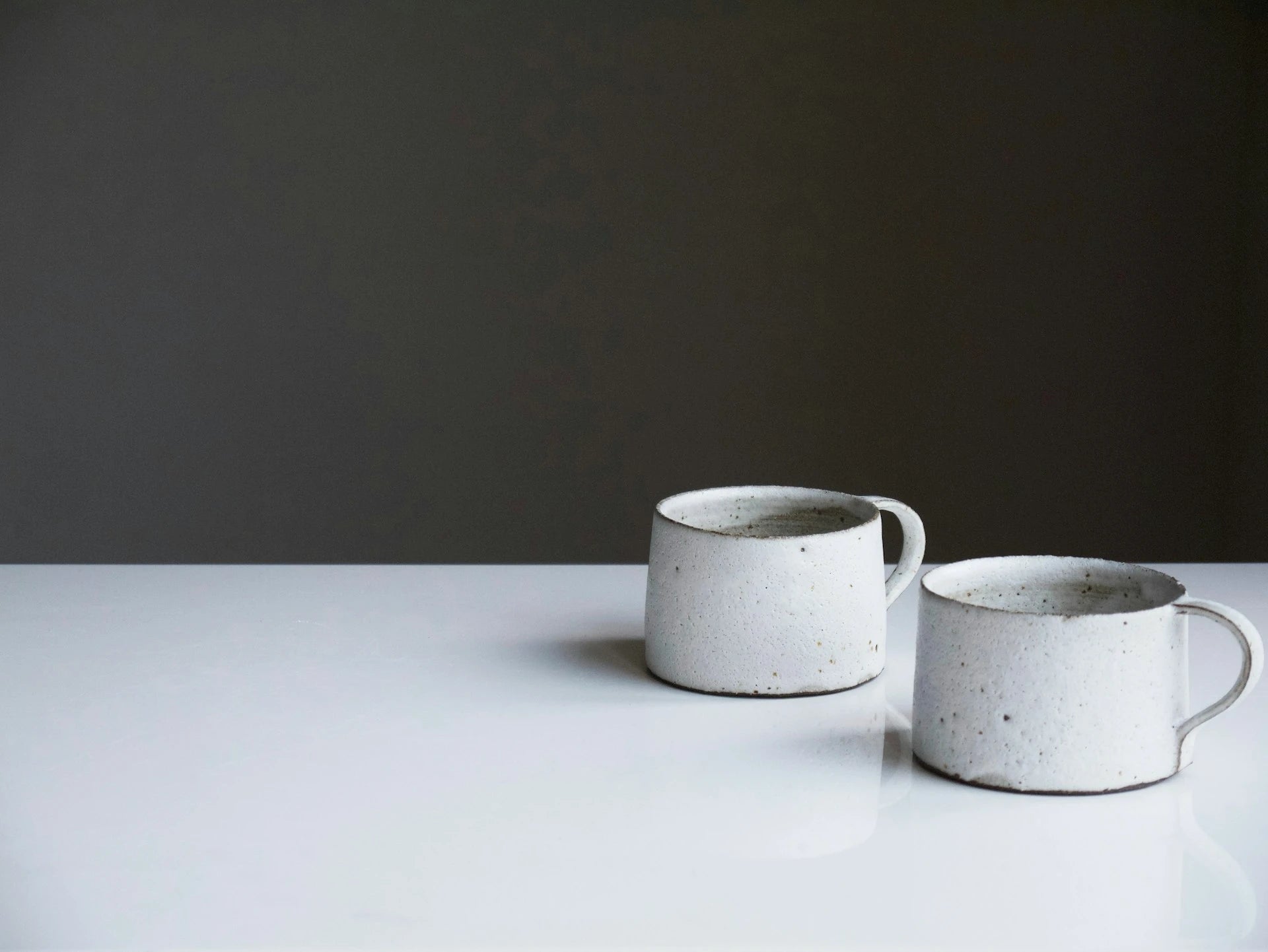 Two cups on a white table